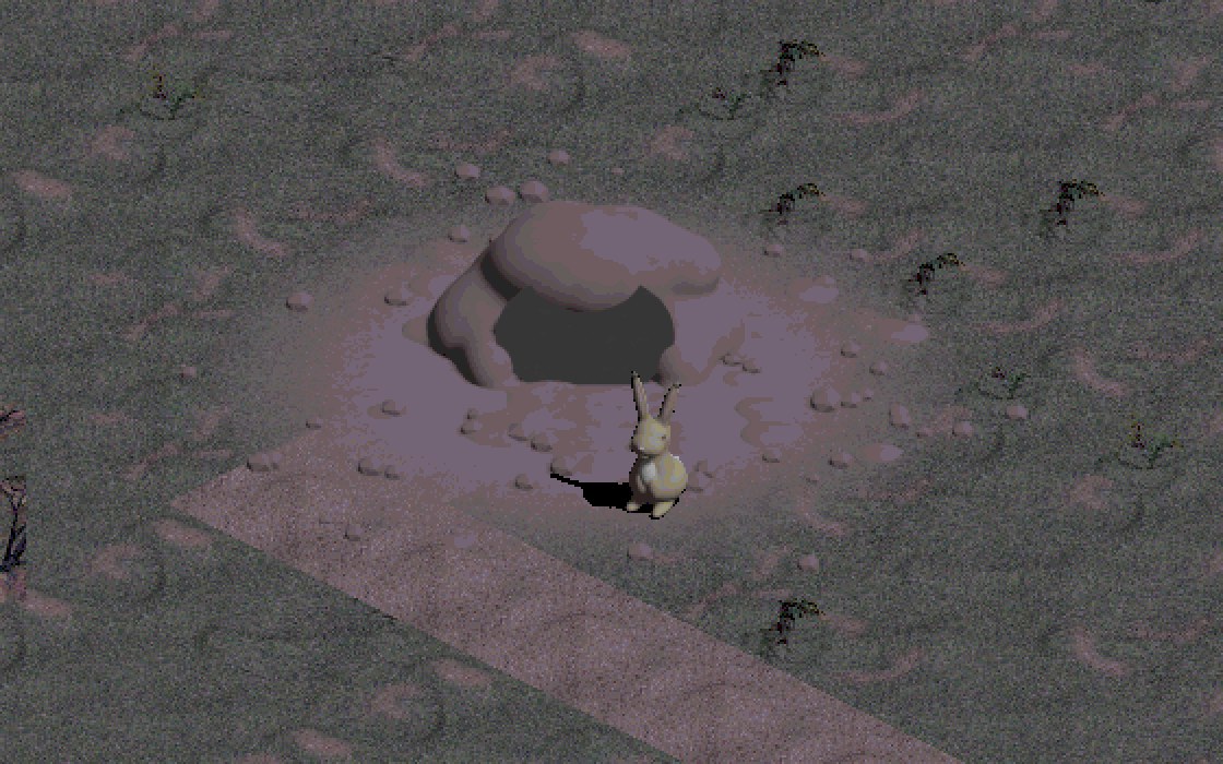 The second rabbit hole: a burrow mouth under a heap of dug earth, churned dirt and clods around it, the rabbit sitting in front